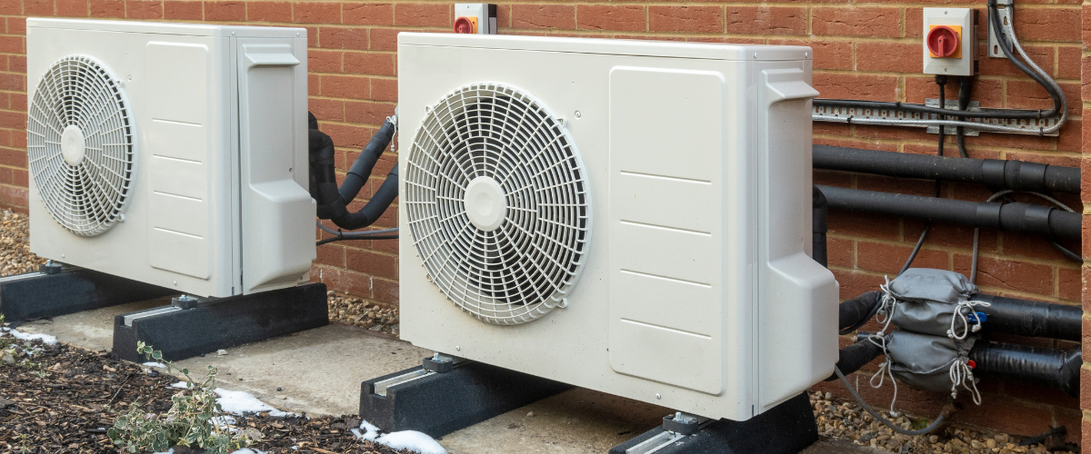 Two heat pumps pictured outdoors